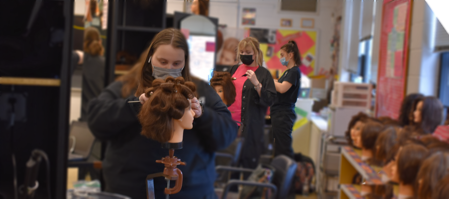 3 girls curling hair.png