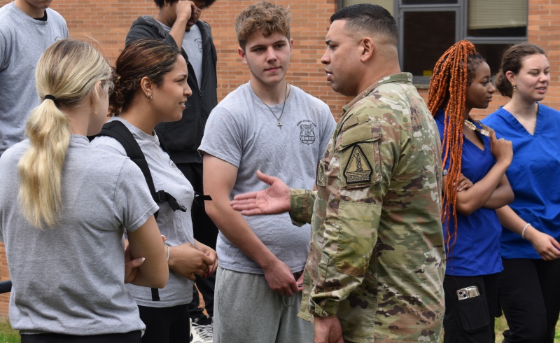 : Air National Guard members shake hands with students after the exercise.