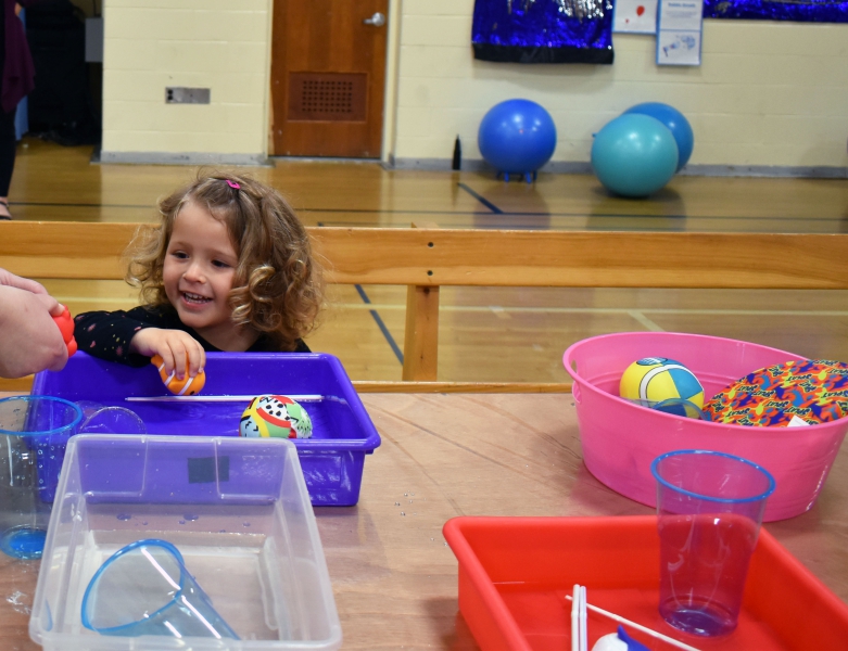 A  young visitor experiments with the water sensory activity at Salt Point Center.