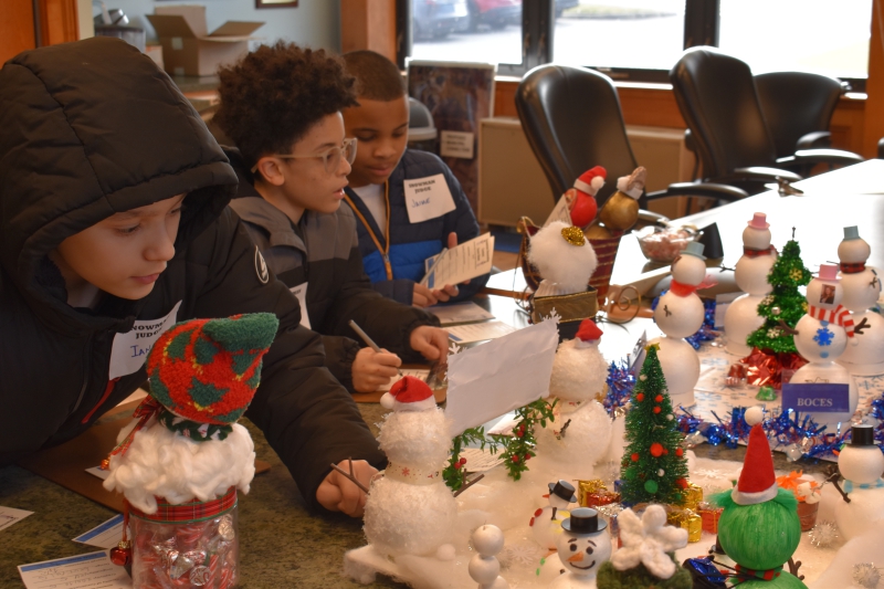 SPC students Ian Rios, Kevin Rodriguez and Jaime Rivera judge snowmen built by administrators.