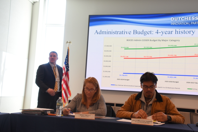 Assistant Superintendent for Business and Operations Mike Skerritt presents information about the agency's 2026-27 administrative budget, in front of a slide showing a four-year history.