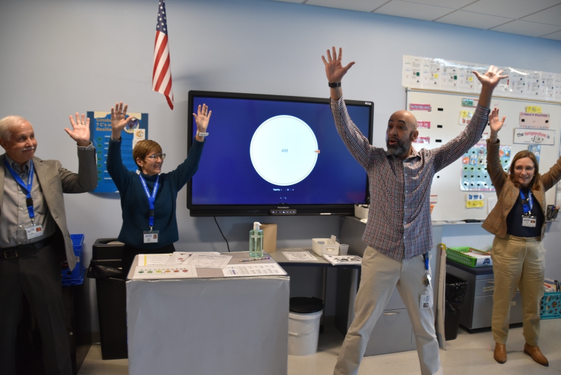 RA Teacher Sam Rivera leads board members in movement during a class.