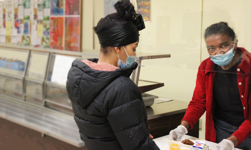 Shirley Caraway, a food service helper at BOCES' Alternative High School serves lunch to student Carina Ortiz.