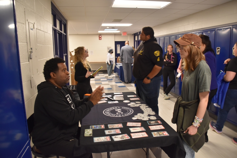 Attendees at the Skilled Trades Fair at Dutchess BOCES speak with representatives from Stockade Works about opportunities in the film industry.