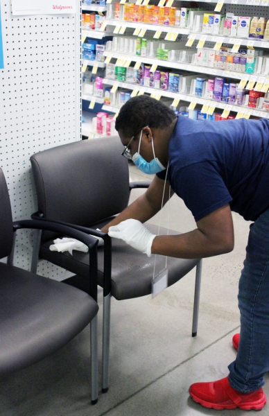Malcom Lewis cleans a chair in the pharmacy department.