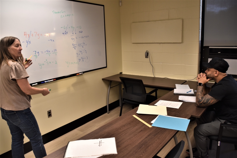 GED Teacher Dianne Ham works on a math problem with a student.