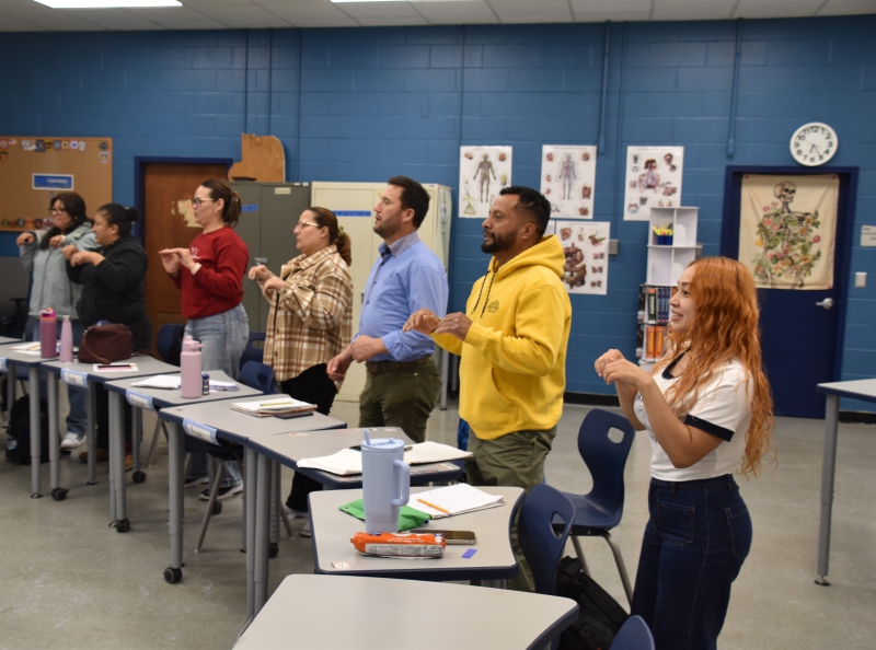 Students in the English for Speakers of Other Languages class sing the "Gray Squirrel Song" to practice phrases they've learned.