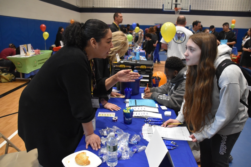A representative from Mid Hudson Valley Federal Credit Union speaks with a student at the Resilience Academy's first Career Exploration Fair.