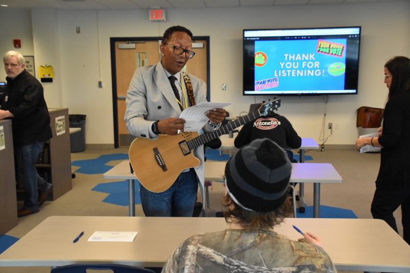 Dutchess County Board of Elections Specialist Wilford Bryan Lammers reviews a voter registration form from a student during a visit to Dutchess BOCES' Resilience Academy