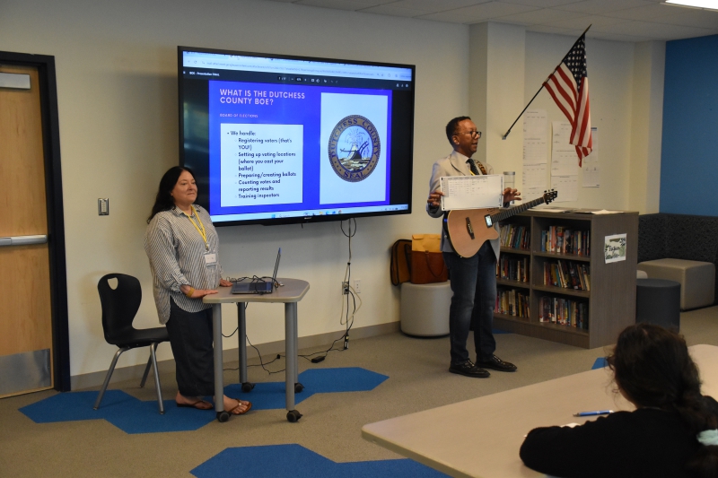 Dutchess County Elections Specialist Wilford Bryan Lammers shows students a sample ballot.
