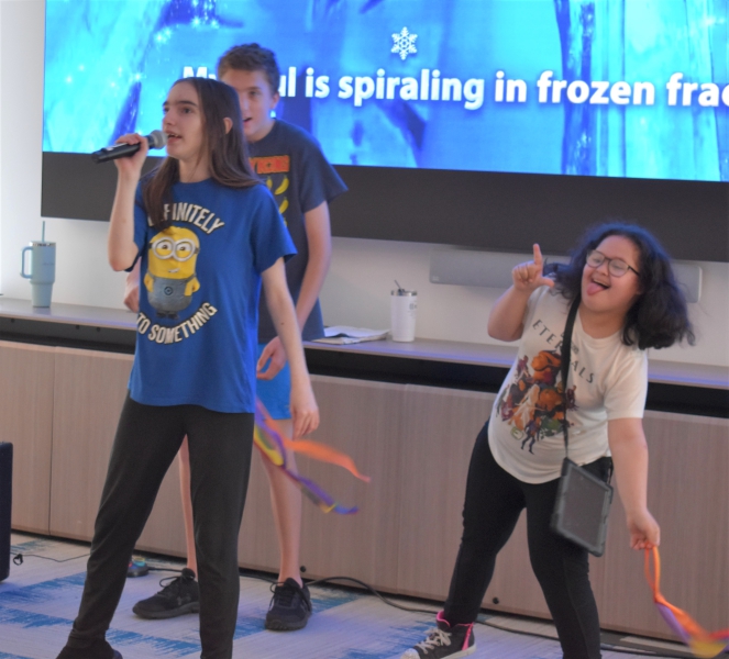 Students sing and dance to a song from the movie, "Frozen."