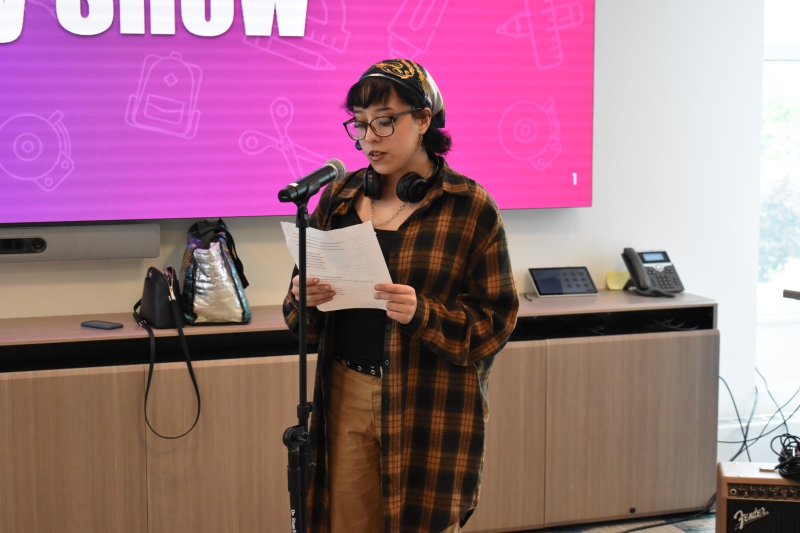 A student reads a poem they wrote for the show.