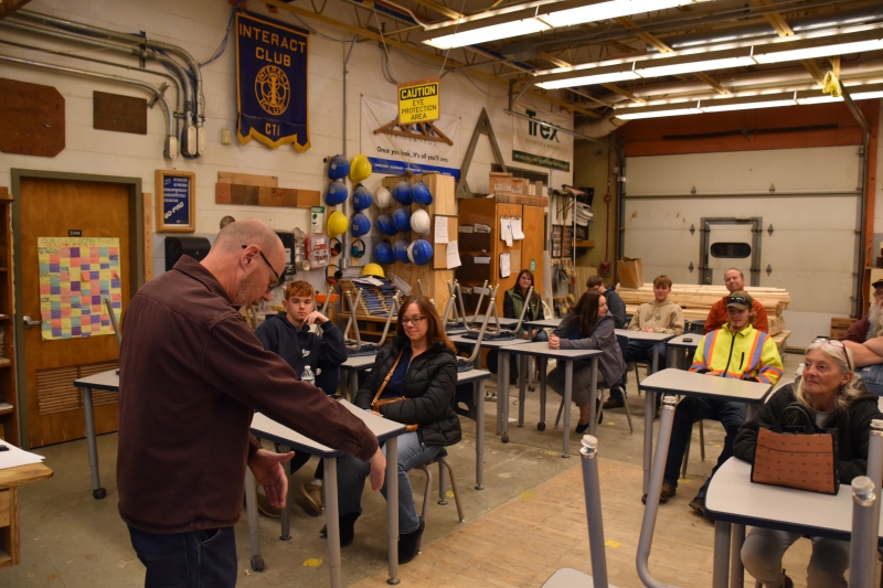 Construction Trades Teacher Tom Skeane speaks to parents about some of the skills students learn in the program during the Open House.