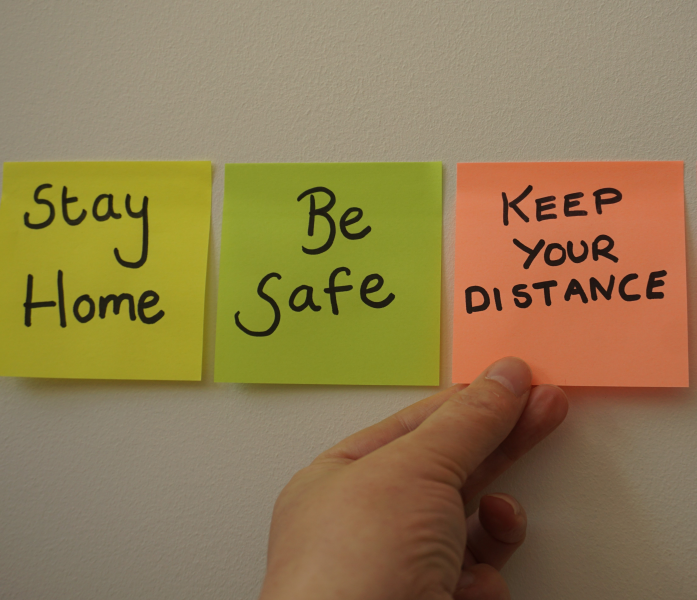 Photo of sticky notes saying stay home, be safe and keep your distance