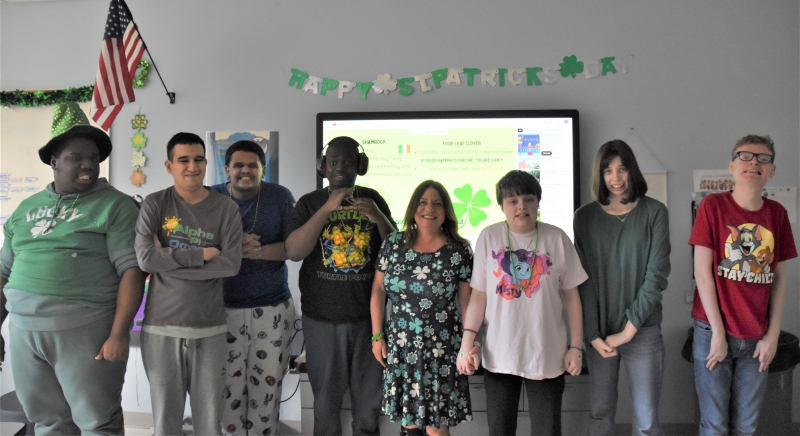Students in Sheri Tompkins class dressed in green and posed for a photo.