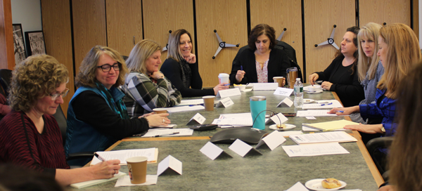 [PIC] School District Clerks Sitting At Board Room Table Together