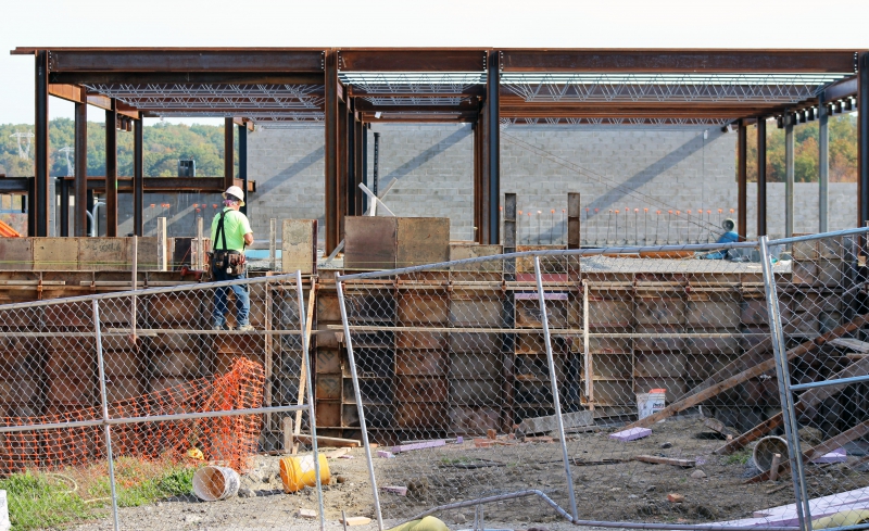 A construction worker works on a wall at the Career and Technical Institute.