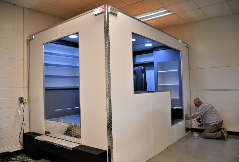 Brent Baugus from Rescue Simulation Products installs the final panel on the simulator.