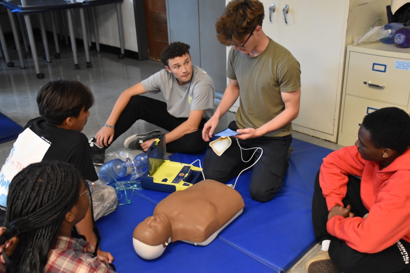 Students in the EMT and Security and Law programs learn how to use an AED device.