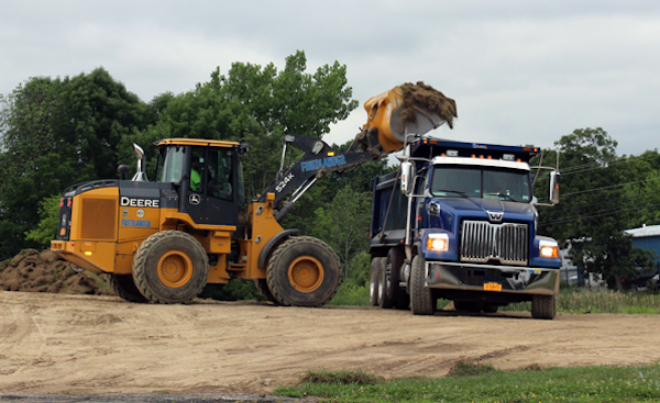 [PIC] Backhoe Dumps Soil Into Dump Truck As Part Of Dutchess BOCES Campus Capital Project