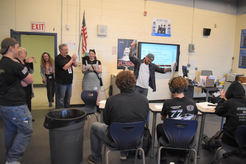 Jake Maneri celebrates in his classroom after receiving Q92's Teacher of the Month award.