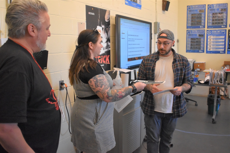 Q92's Felicia Kirschner presents Jake Maneri with the Teacher of the Month award in class