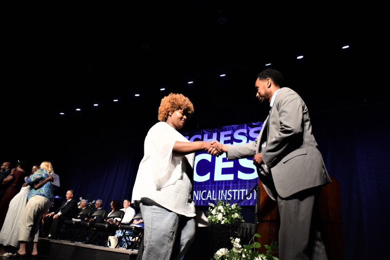 Nursing Assistant student Chelsea Stephens shakes hands with CTI Assistant Principal Damian Lamm after receiving her certificate.