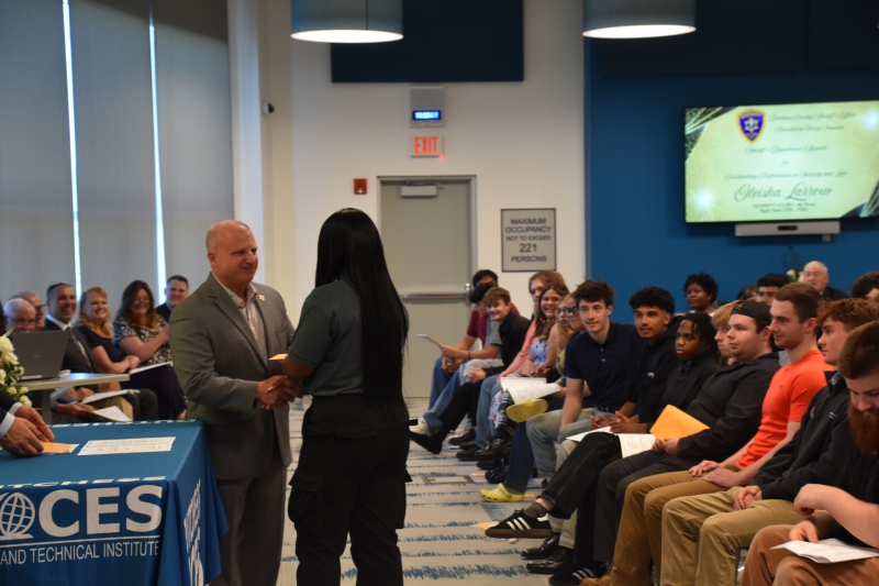 CTI Security and Law student Oleisha Larrow receives an award from Dutchess County Sheriff Kirk Imperati at the ceremony.