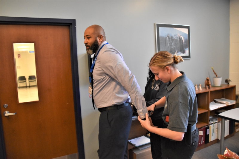 CTI Principal Jason Lloyd is 'arrested' by Security and Law students based on a scenario generated by artificial intelligence to help students practice arrest procedures.