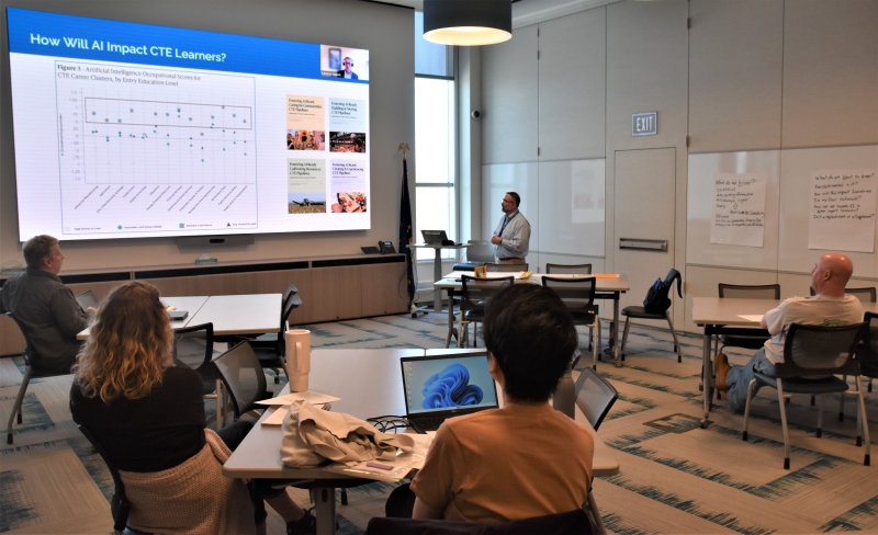 Director of CTE and Adult Education Nicholas Millas speaks with teachers on the impact of artificial intelligence on CTI students.