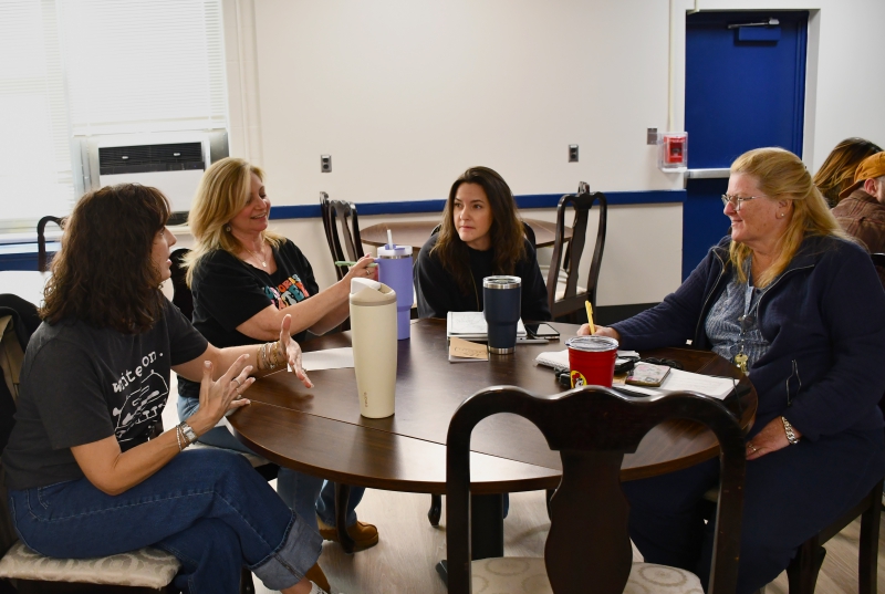 Staff members discuss one of the scenarios presented during the Rapid Fire Scenario session, designed to help make decisions.