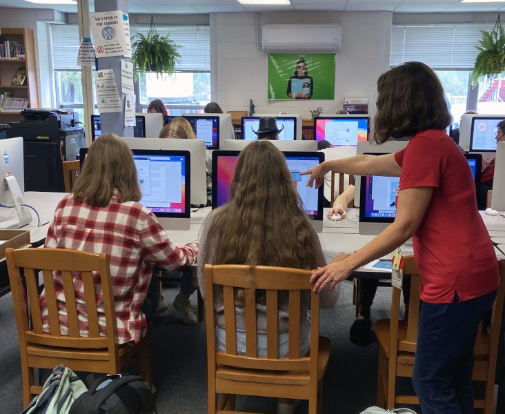 Red Hook Library Media Specialist Tanya Sasvary works with students in the library.