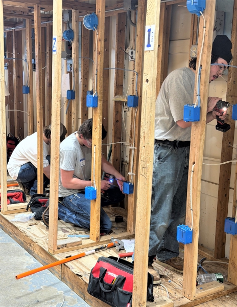 Students perform electrical work as part of the competition.