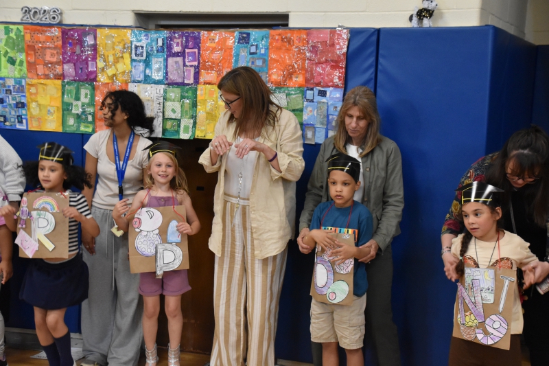 Students hop to a song during the Kindergarten Alphabet Parade and Moving Up Ceremony.