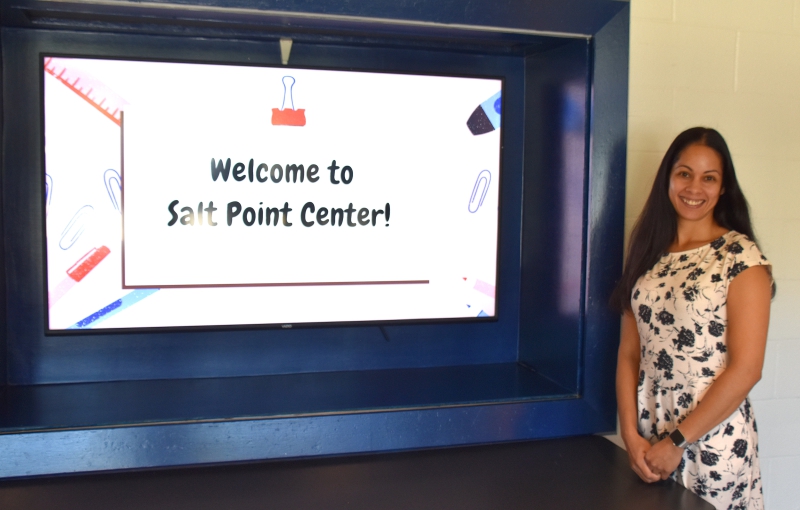 Salt Point Center's new Assistant Principal, Elsie Reynoso is shown by the school's welcome sign.
