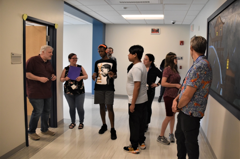 Resilience Academy Teacher James Baker greets SPC eighth graders as they tour the facility they'll be attending next year.