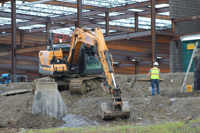 An extractor moves dirt at CTI as part of the capital project.