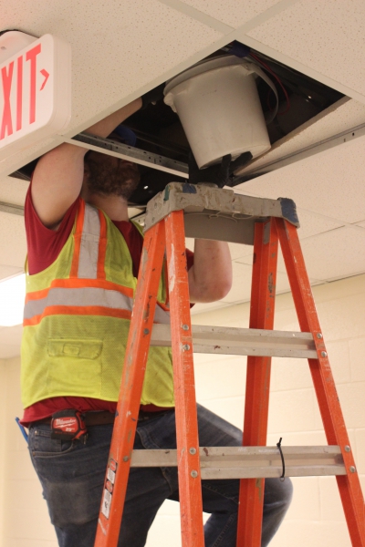 A worker removes water from the ceiling at Salt Point Center.